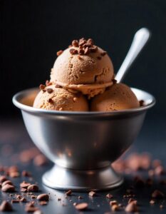 Close-up of a spoonful of velvety coffee ice cream served in a chilled bowl.